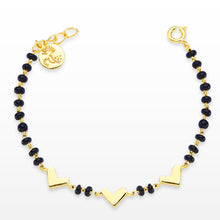 Load image into Gallery viewer, A bracelet with black beads and gold polishing, featuring three gold-colored heart charms.