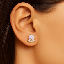 Load image into Gallery viewer, Close-up of an ear wearing a small round earring with a design on a blurred background
