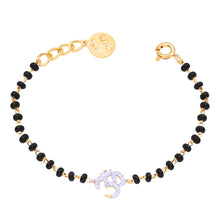 Load image into Gallery viewer, Bracelet with black beads and gold accents on a white background
