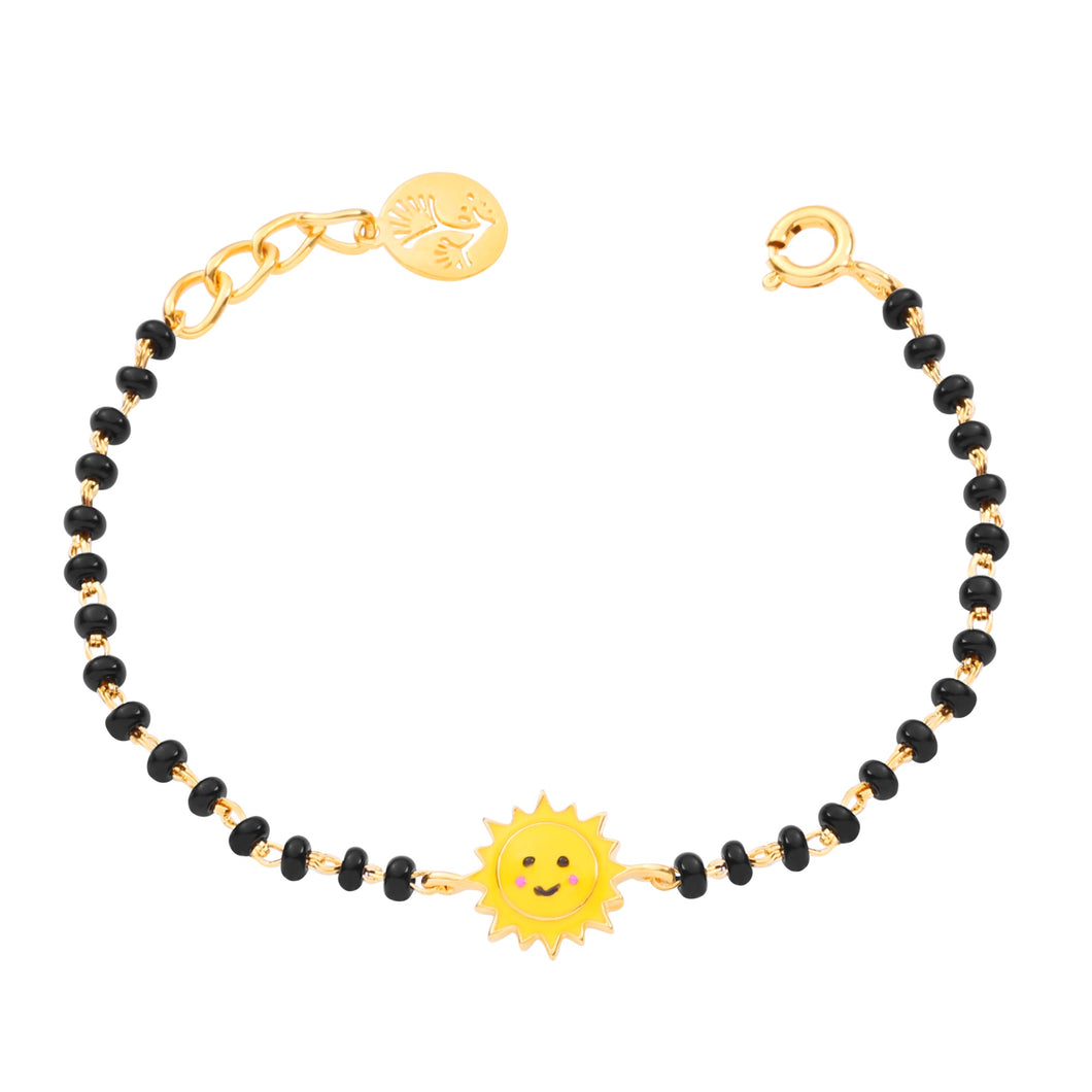 Bracelet with black beads and a yellow sun charm on a white background