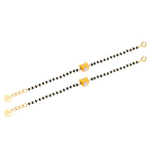 Load image into Gallery viewer, Two gold bracelets with black beads on a white background
